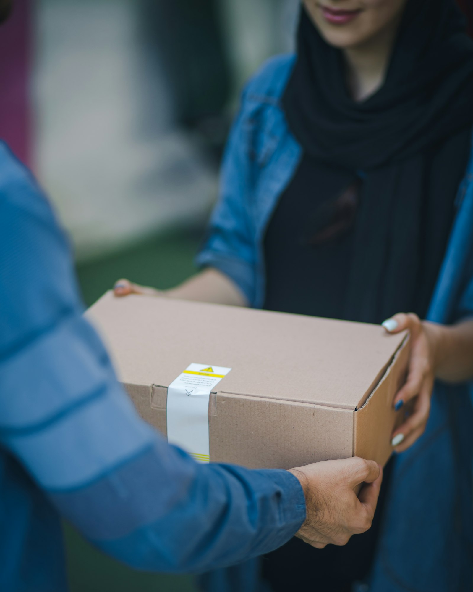 A food parcel being handed from one person to another